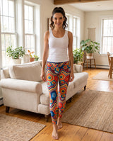 Woman standing in colorful crochet-print high-waist leggings in a living room