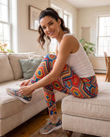 Side view of colorful crochet-print leggings as a woman ties her sneaker