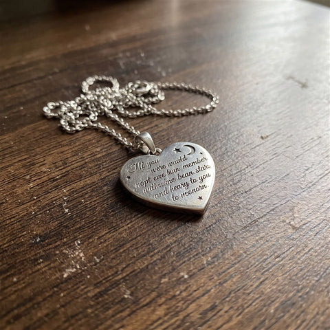 Close-up of the engraved heart pendant on a silver chain