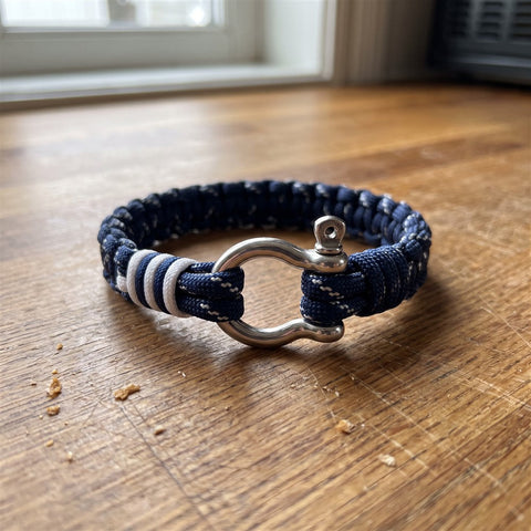 Close-up of a navy paracord bracelet with a stainless steel shackle clasp